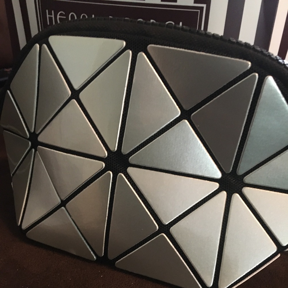 Silver/black cosmetic case . Black zipper. Opens wide. NWT